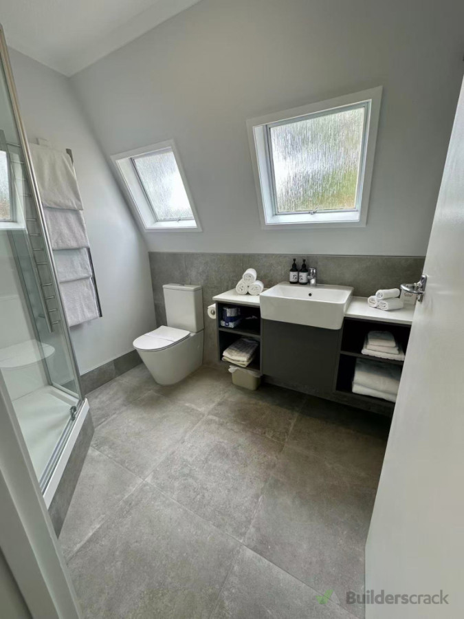Fully demolished. New shower base built up to match shower tray due to the original piping systems. Custom made vanity for commercial purpose.