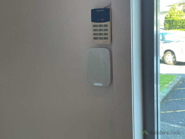AJAX alarm system keypad next to old key pad