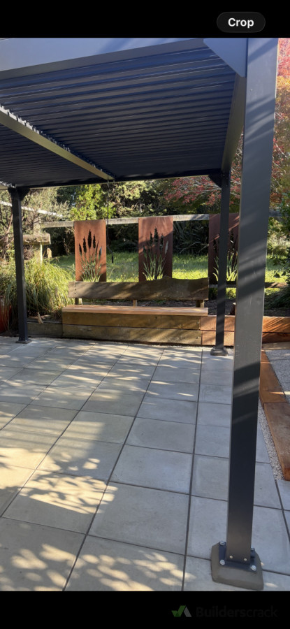 Outdoor space refresh. New pavers, existing macrocarpa seat and steps repaired, new louvre installed and decorative steel panels fixed to existing fence.