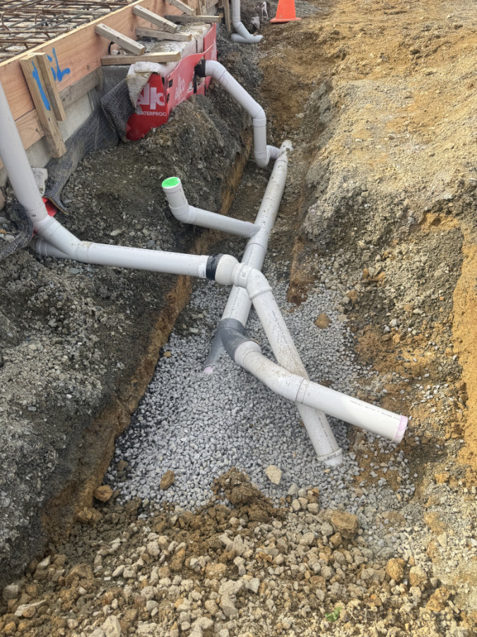100mm SN16 PVC stormwater down pipes and 100mm SN16 PVC Sewer pipes with a flexible join exiting building foundation