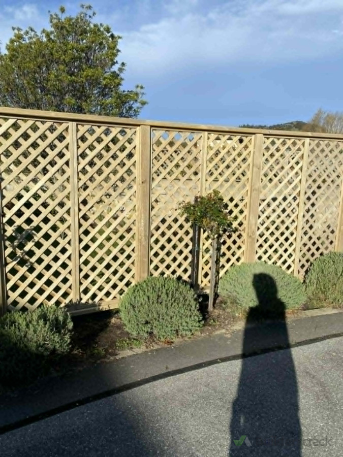 "Timber trellis fence installation—adding privacy and a clean border to the property."