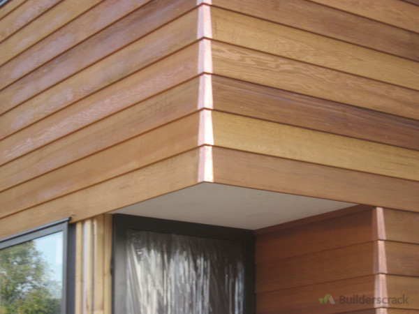 Copper corner soakers, cedar weatherboards, perfect cut out around the window  head flashing with 5 mm gap above door to soffit 10/10