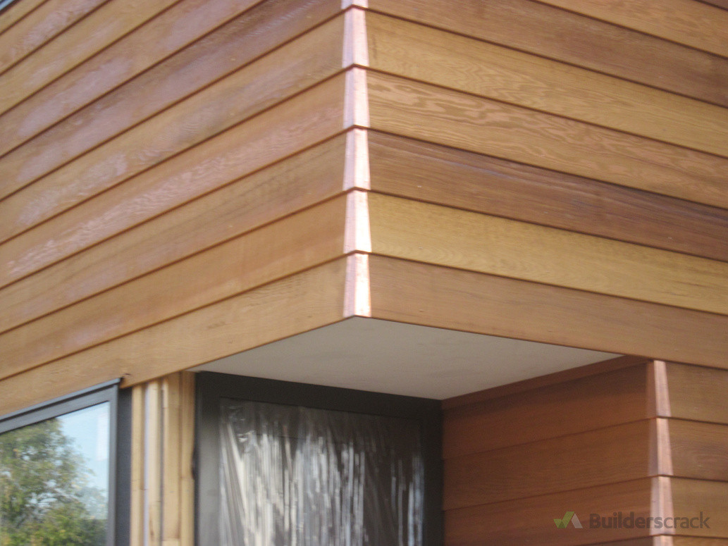 Copper corner soakers, cedar weatherboards, perfect cut out around the window  head flashing with 5 mm gap above door to soffit 10/10