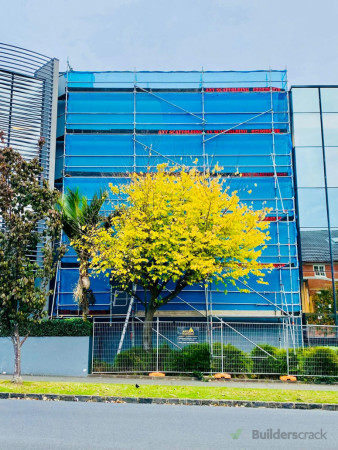 Perimeter commercial scaffold with safety mesh.