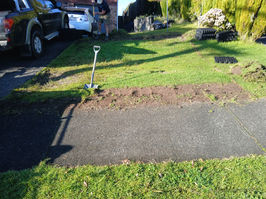 Remove grass and soil by hand due to rocks and services.