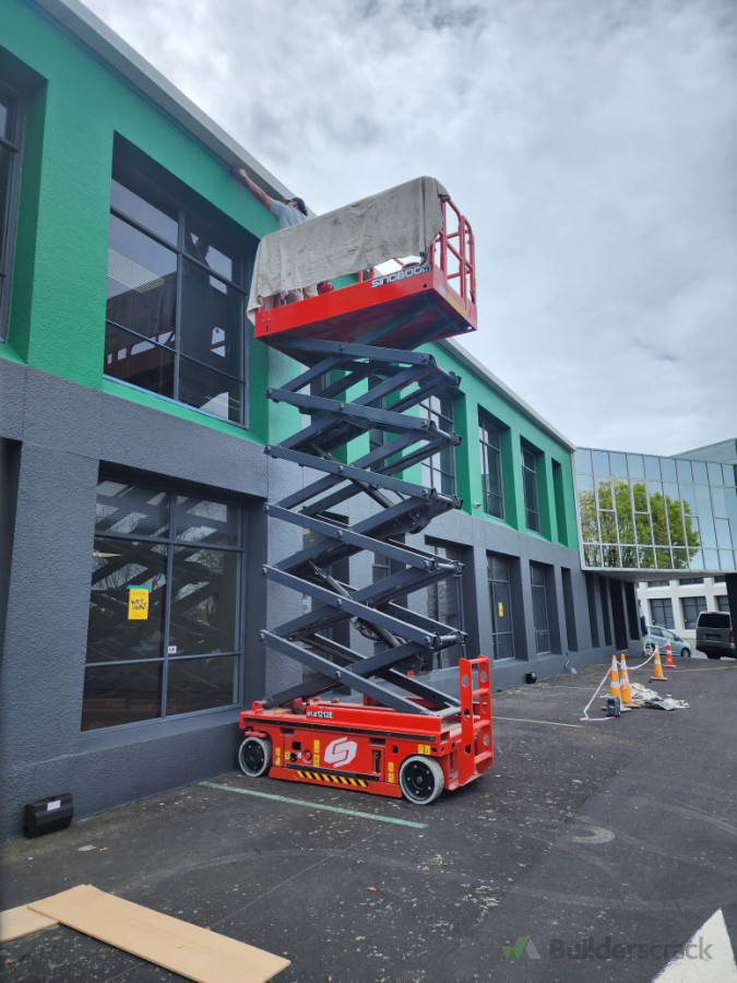 Scissor lift to paint the exterior on a commercial building