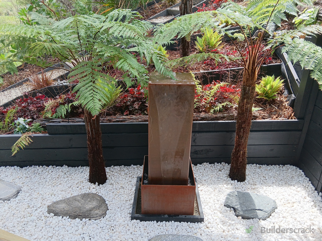 The garden includes a simple water feature that enhances the peaceful atmosphere of the outdoor space.