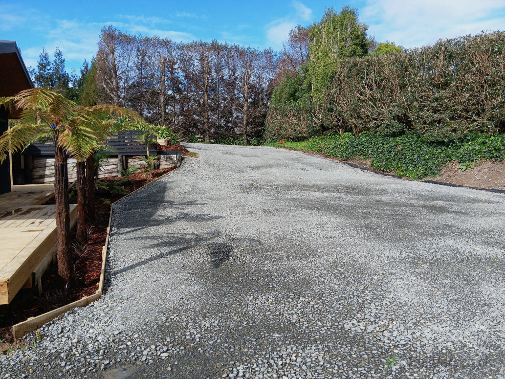 We upgraded the driveway by clearing and levelling the area and adding crushed stone (metal) to create a durable, all-weather surface.