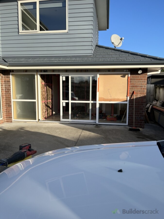 Double garage converted in to two bedrooms and custom window and sliding door to accommodate garage door opening.