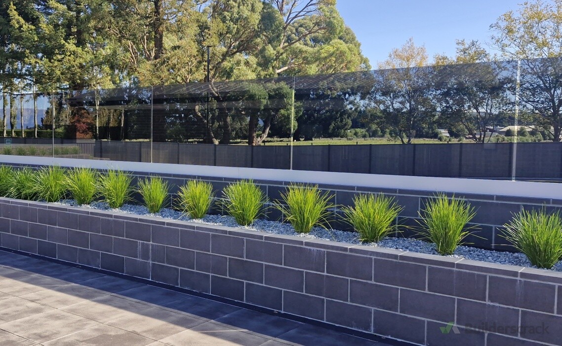 Glass wind break on raised garden