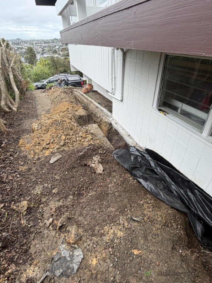 Installing sufficient drainage alongside the dwelling to ensure adequate stormwater management