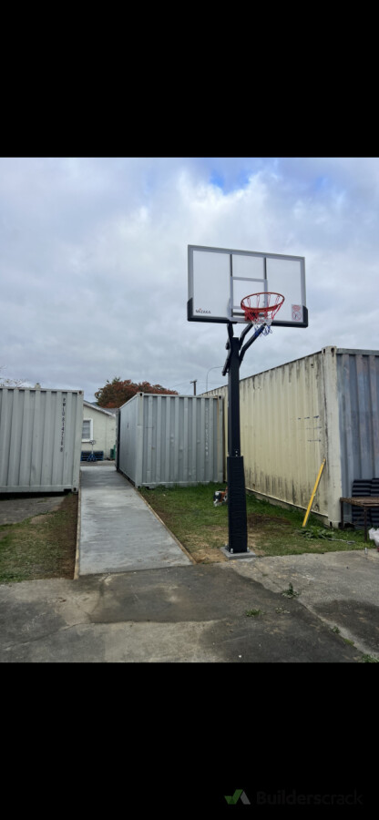 Concrete pathway and basketball hoop installation to complete this outdoor recreation area.