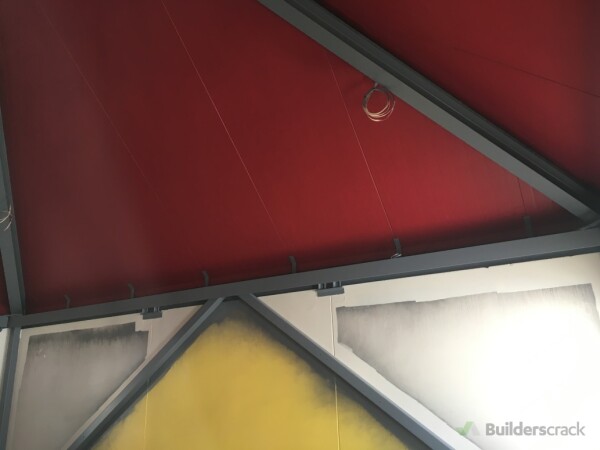 Paint on the Red ceiling and Gray beams