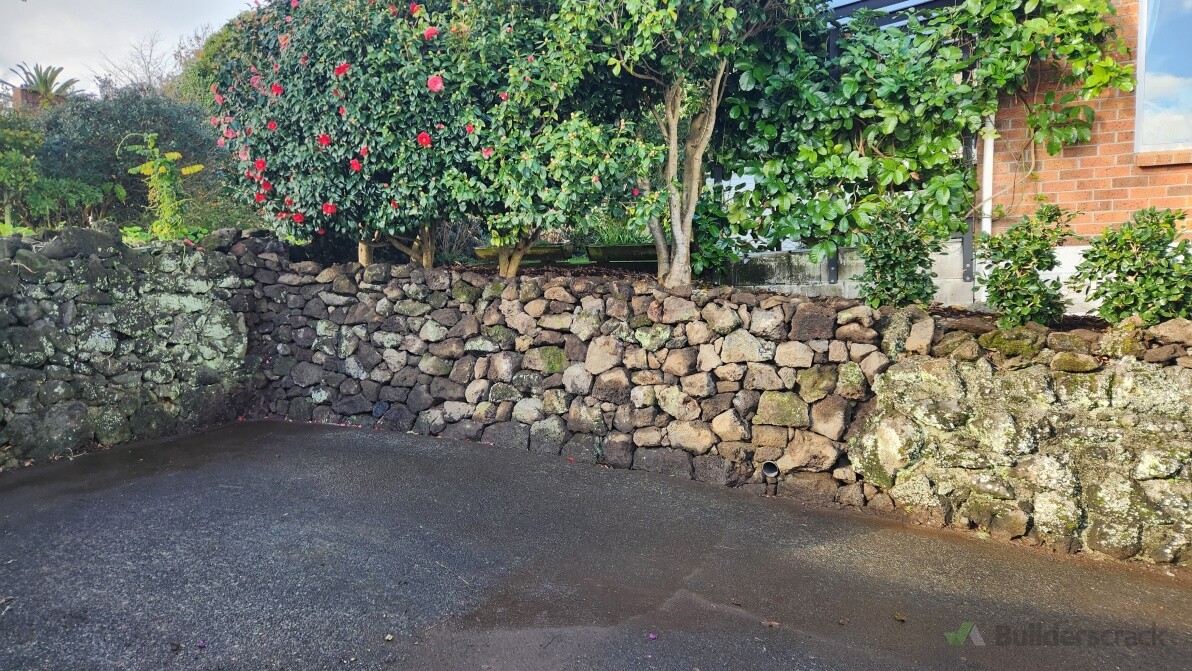 Rebuilt collapsed stone retaining wall