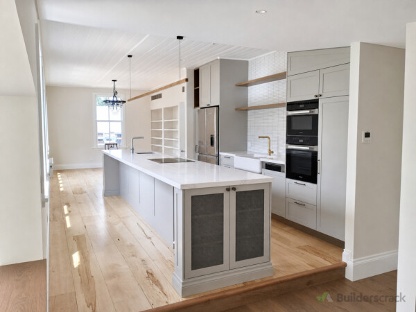 Custom kitchen installation with long island and aligned cabinetry