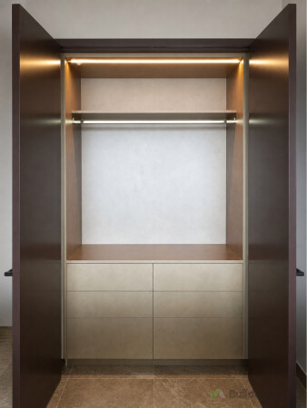 Built-in wardrobe with drawers, hanging space, shelving and integrated lighting