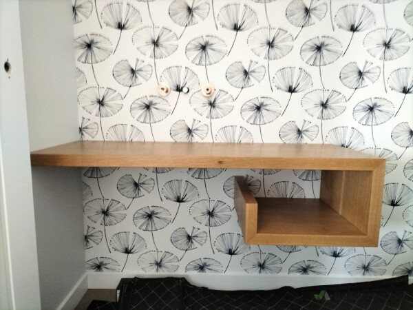 Floating oak vanity with suspended open shelving and clean wall fitting