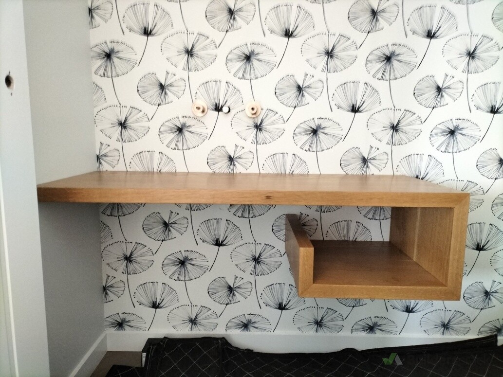 Floating oak vanity with suspended open shelving and clean wall fitting