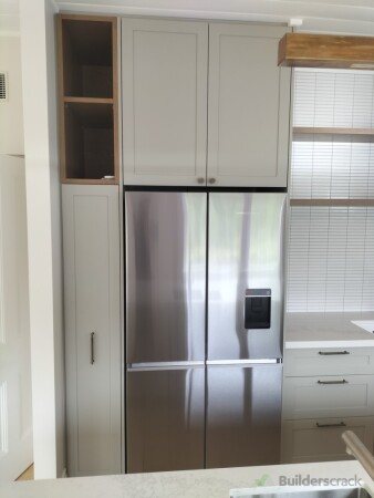 Integrated refrigerator cabinetry with overhead storage and open shelving