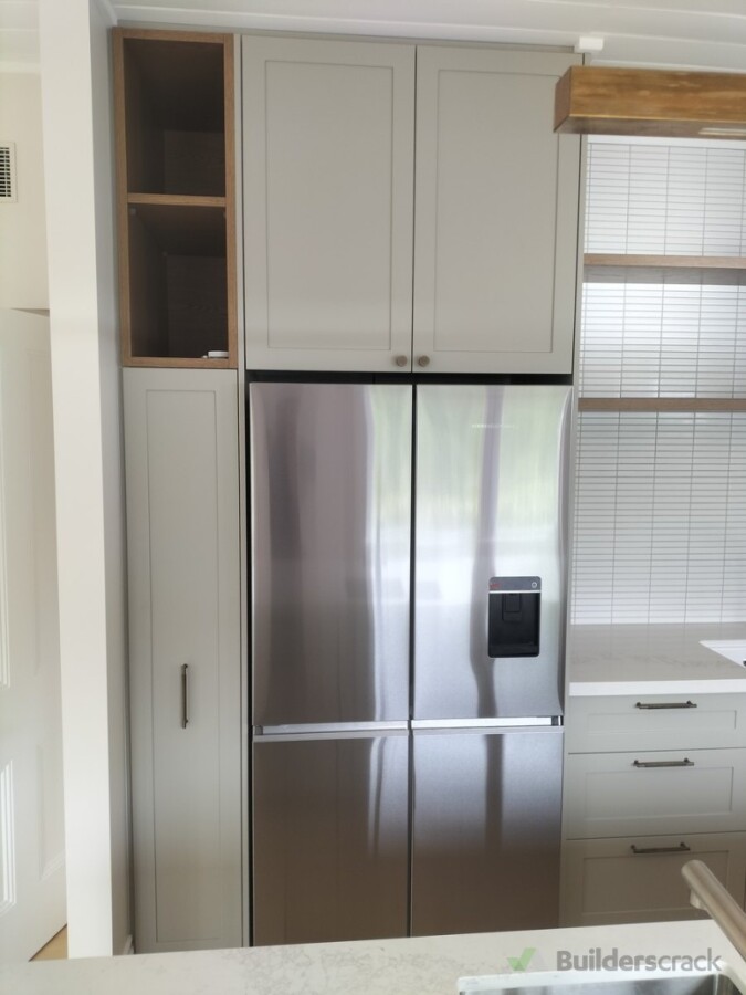 Integrated refrigerator cabinetry with overhead storage and open shelving
