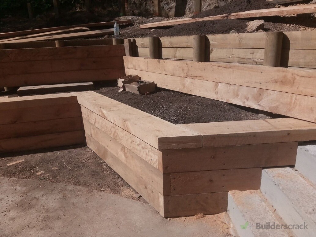 Macrocarpa facings and capping, on a terraced retaining wall.