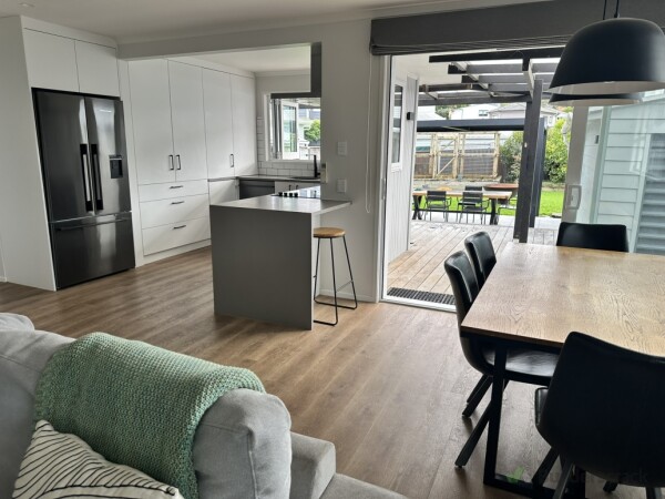 The opened up space with dining and the stacker door