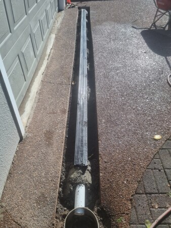 Connected to exisitng cesspit and set in with quick-dry concrete. Taped to keep the grates clean.