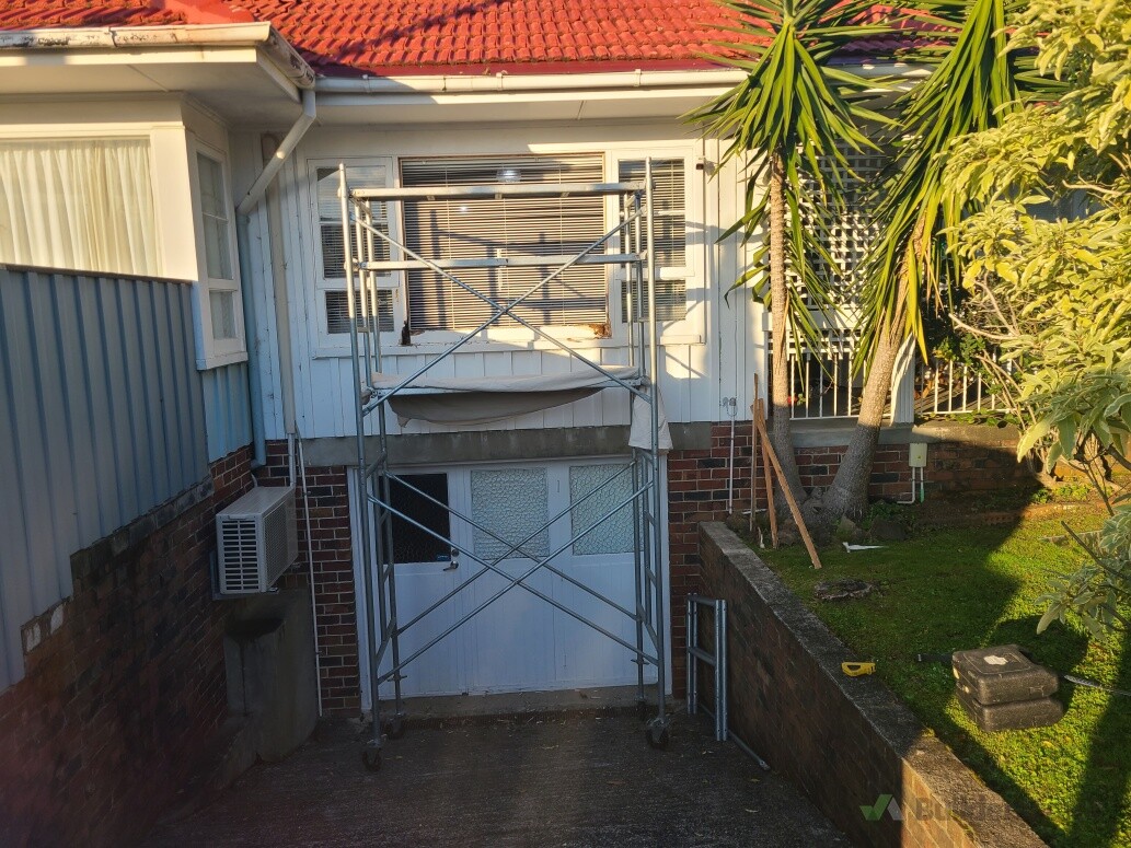 Wooden window glass install off our scaffolding