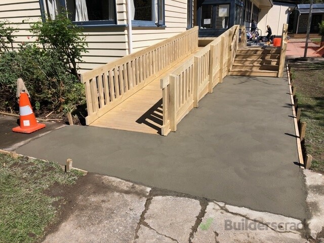 Concrete pathway and wooden access ramp at a local school.