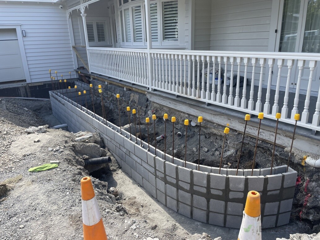 Planter box and retaining wall for concrete driveway