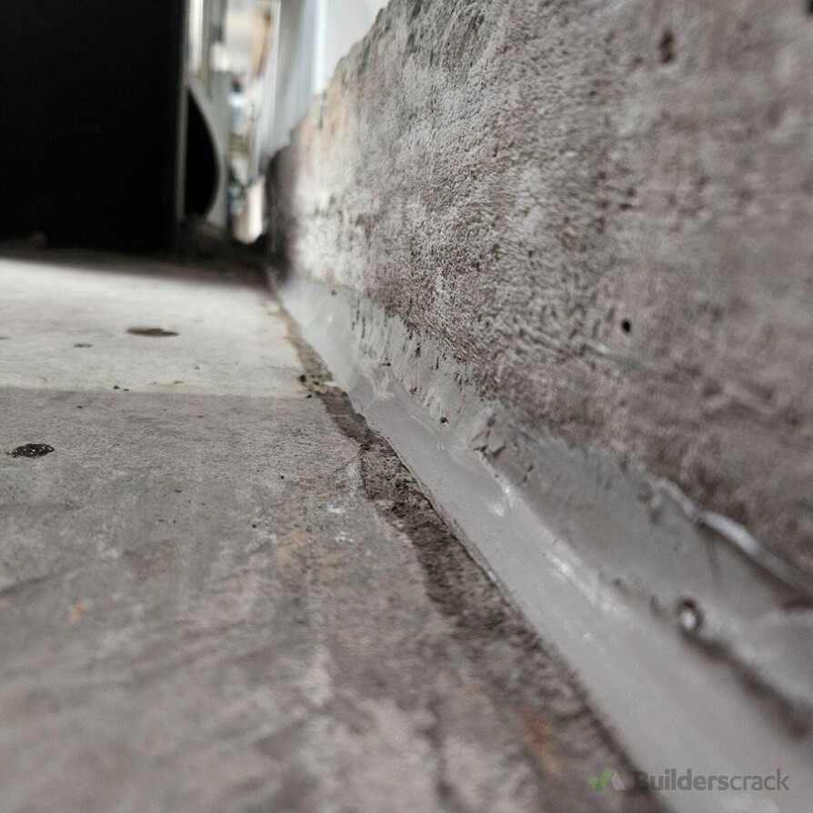 Wall-to-floor junction resealed.