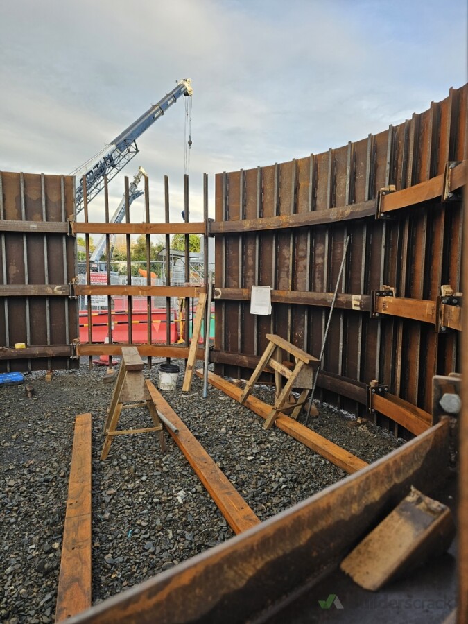 Connecting the pre-constructed circular metal formwork to be used to pour concrete for the wall lining from bottom to top.