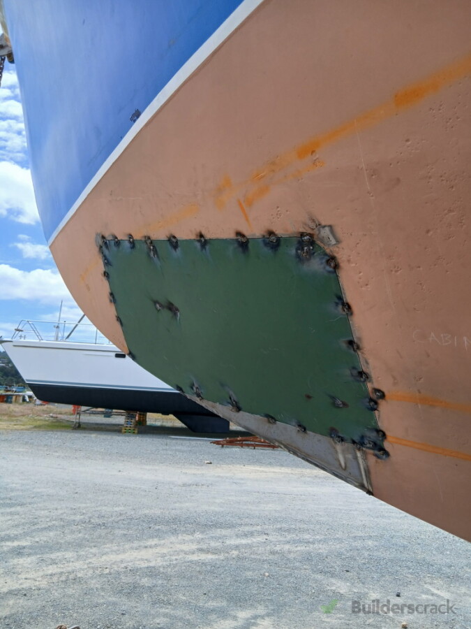 Tack welding on a hull patch for fitment check.