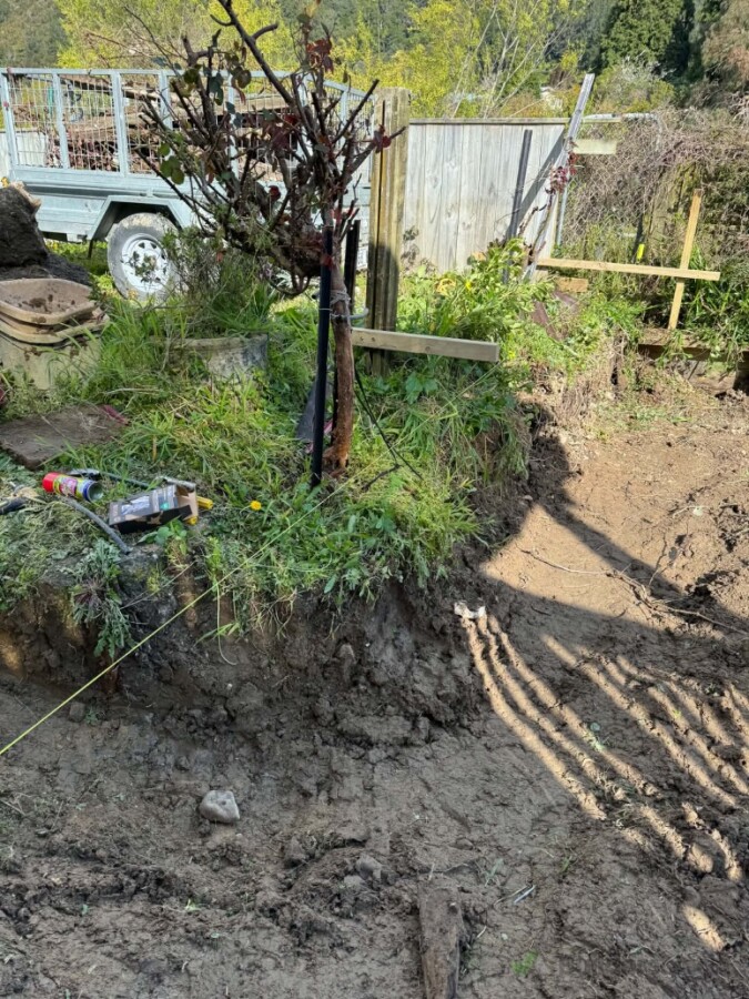 Ground leveling for retaining wall and graveled terrace