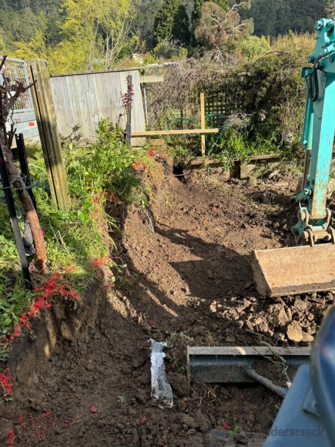 Ground leveling for retaining wall and graveled terrace