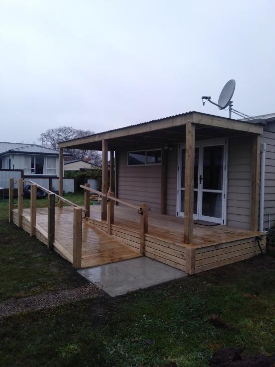 Pine deck with wheel chair access and colour steel pergola.