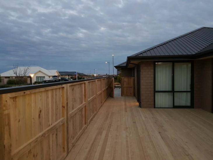 Dressed pailing fence with colour steel capping and pine deck