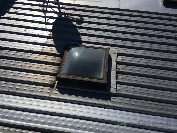 Install new skylights above kitchen and remove 3 leaking skylights