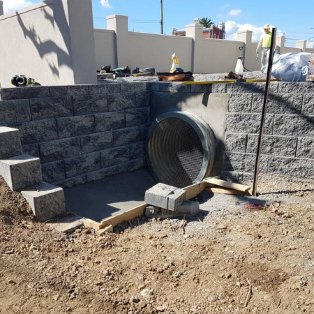 Key stone retaining wall over duct