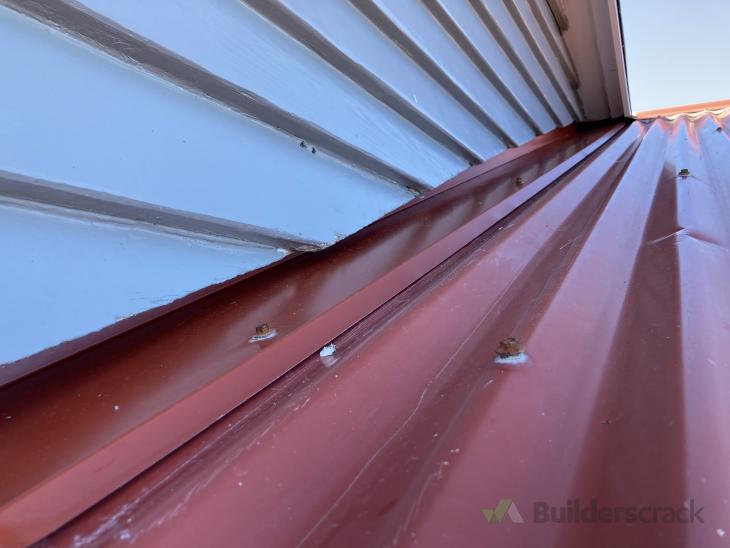 Some rivets required on apex of house and flashing or soffit board ...