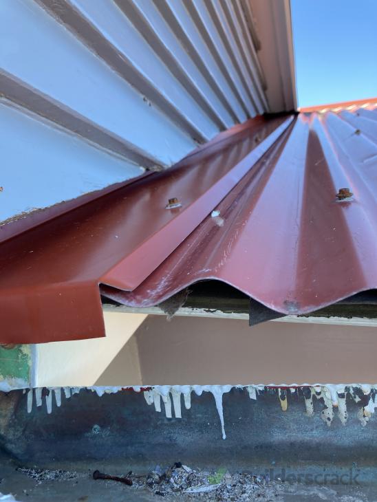 Some rivets required on apex of house and flashing or soffit board ...