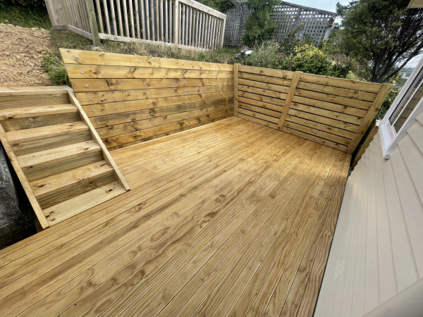 Deck, stairs, retaining wall and a fence