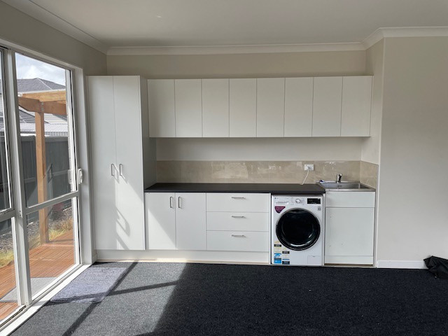 Garage laundry area that is well designed for maximum storage