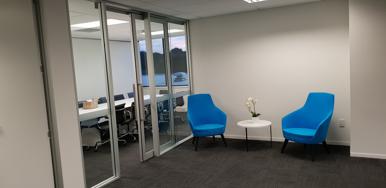 Meeting room created off reception area, built from aluminium extrusion on site including fabrication and hanging of glazed aluminium sliding door and full height glass