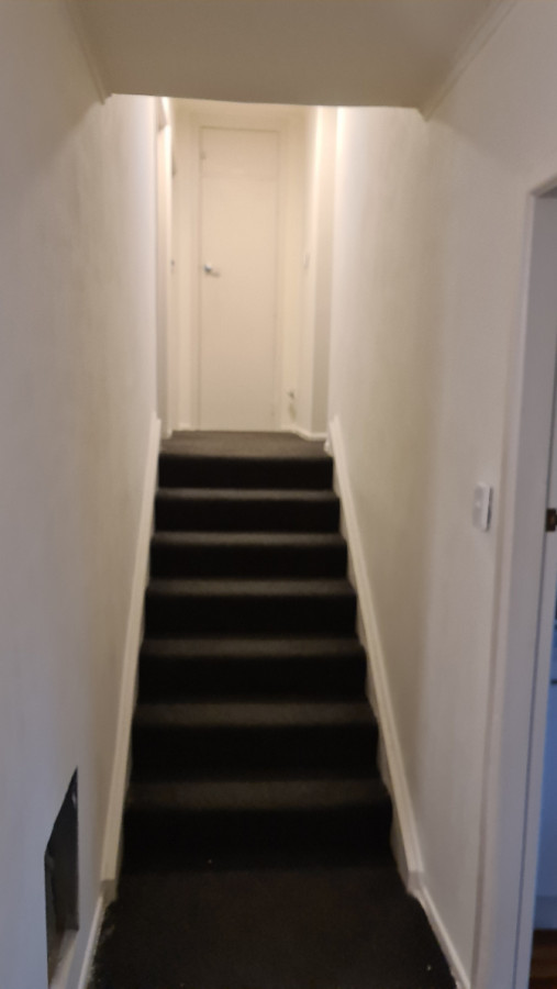 Skimming old wallboards on hallway